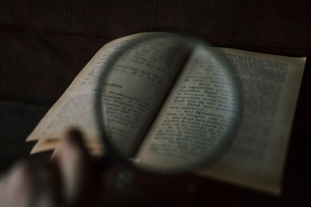 open mystery book with magnifying glass